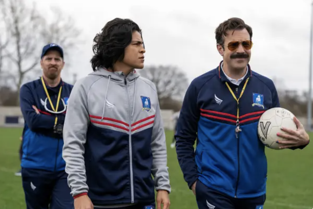Ted Lasso holding a soccer ball