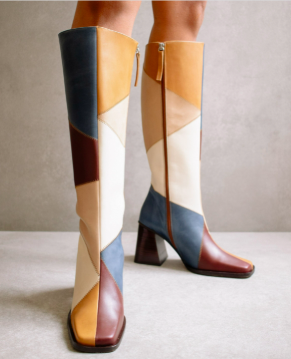 the brown, yellow, white, tan, and navy patchwork boots