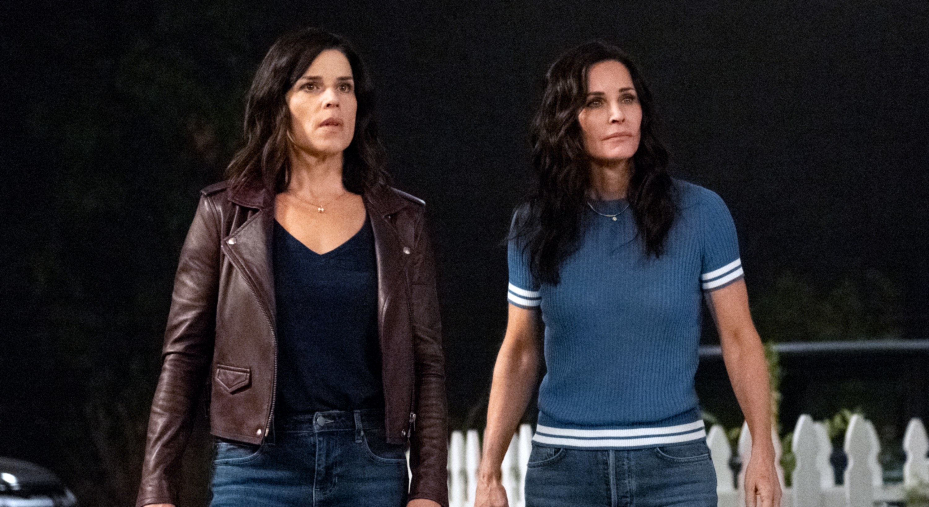 Neve Campbell and Courtney Arquette standing next to each other during a scene