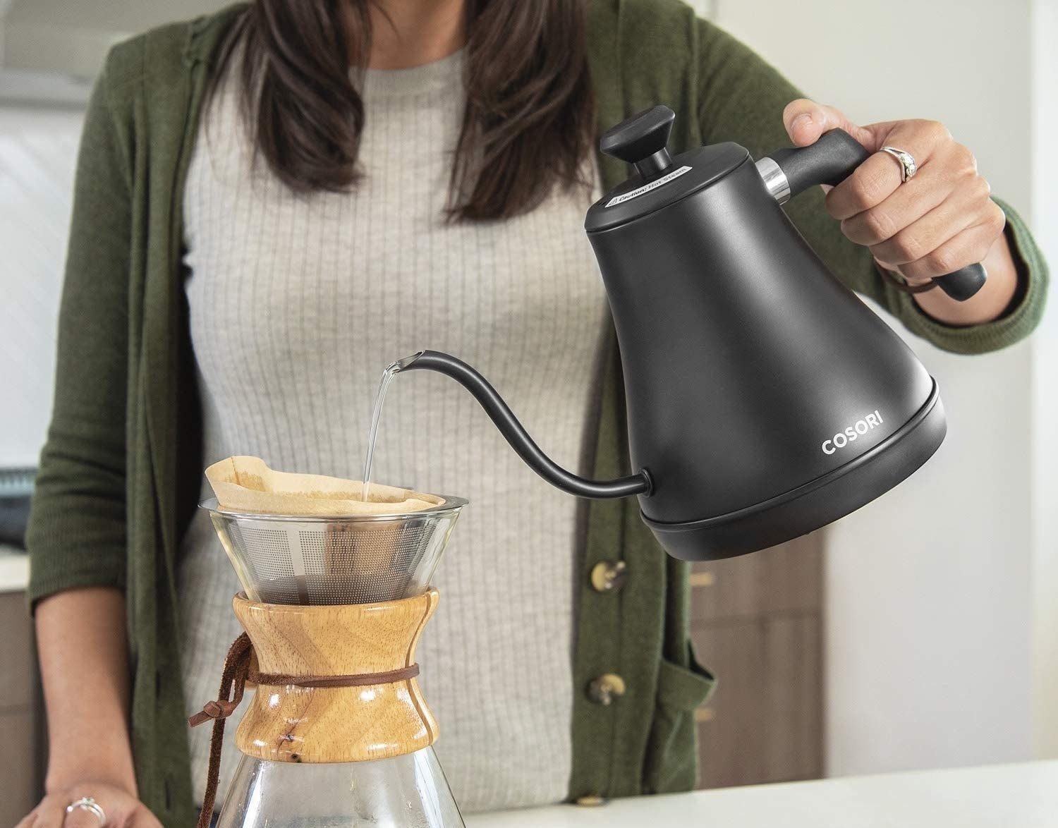 someone using the gooseneck kettle to make pourover coffee