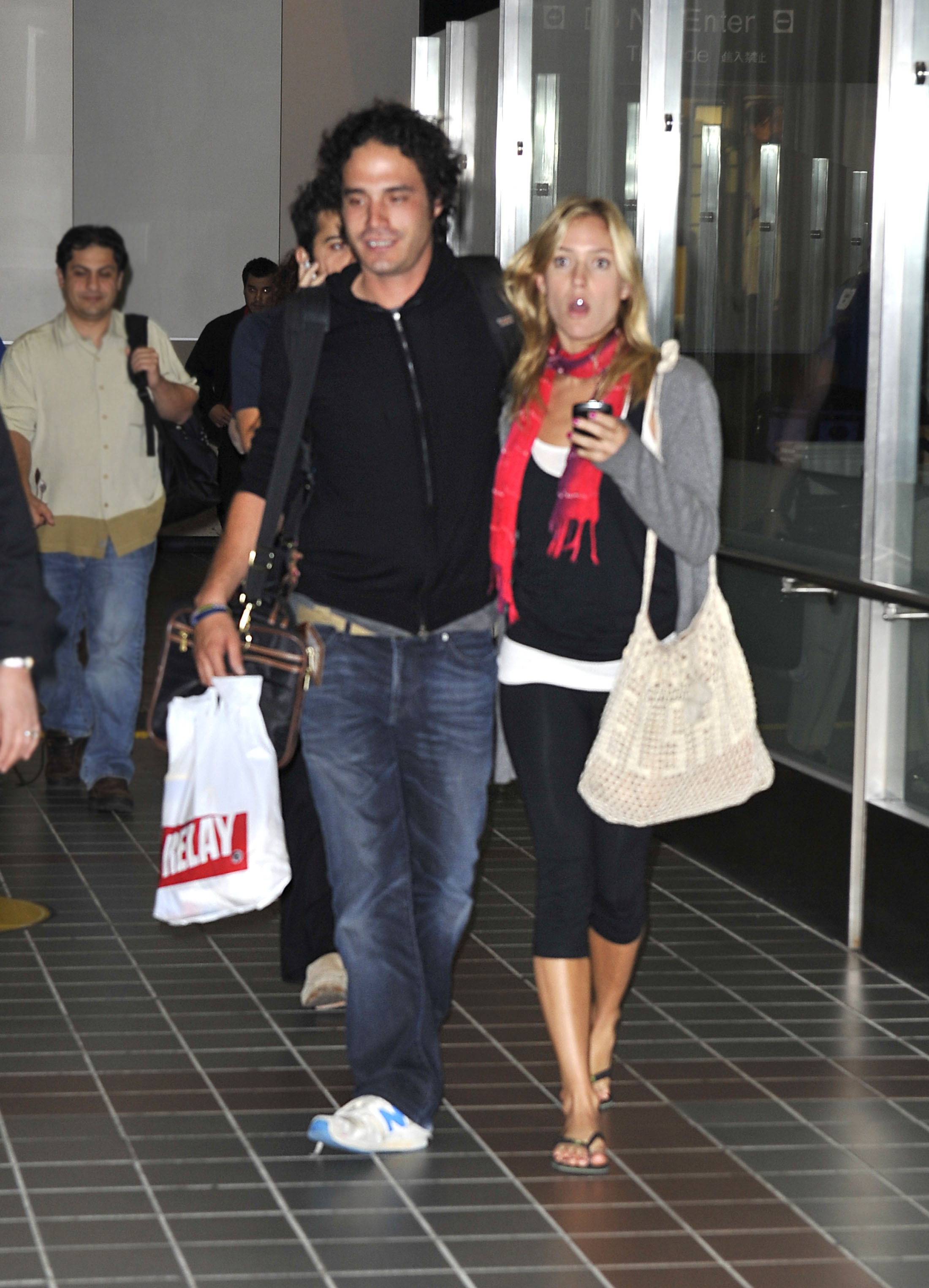 MIguel and Kristin leaving the airport together