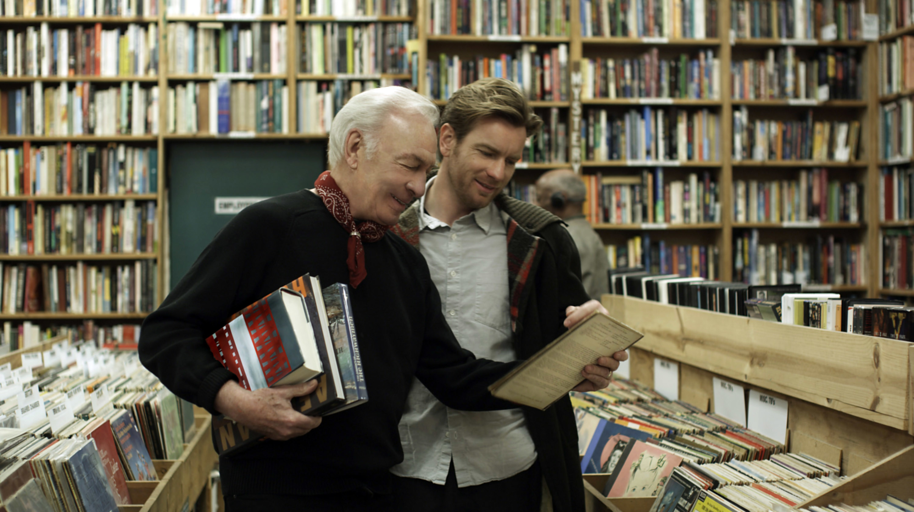 Christopher Plummer and Ewan McGregor look at records together