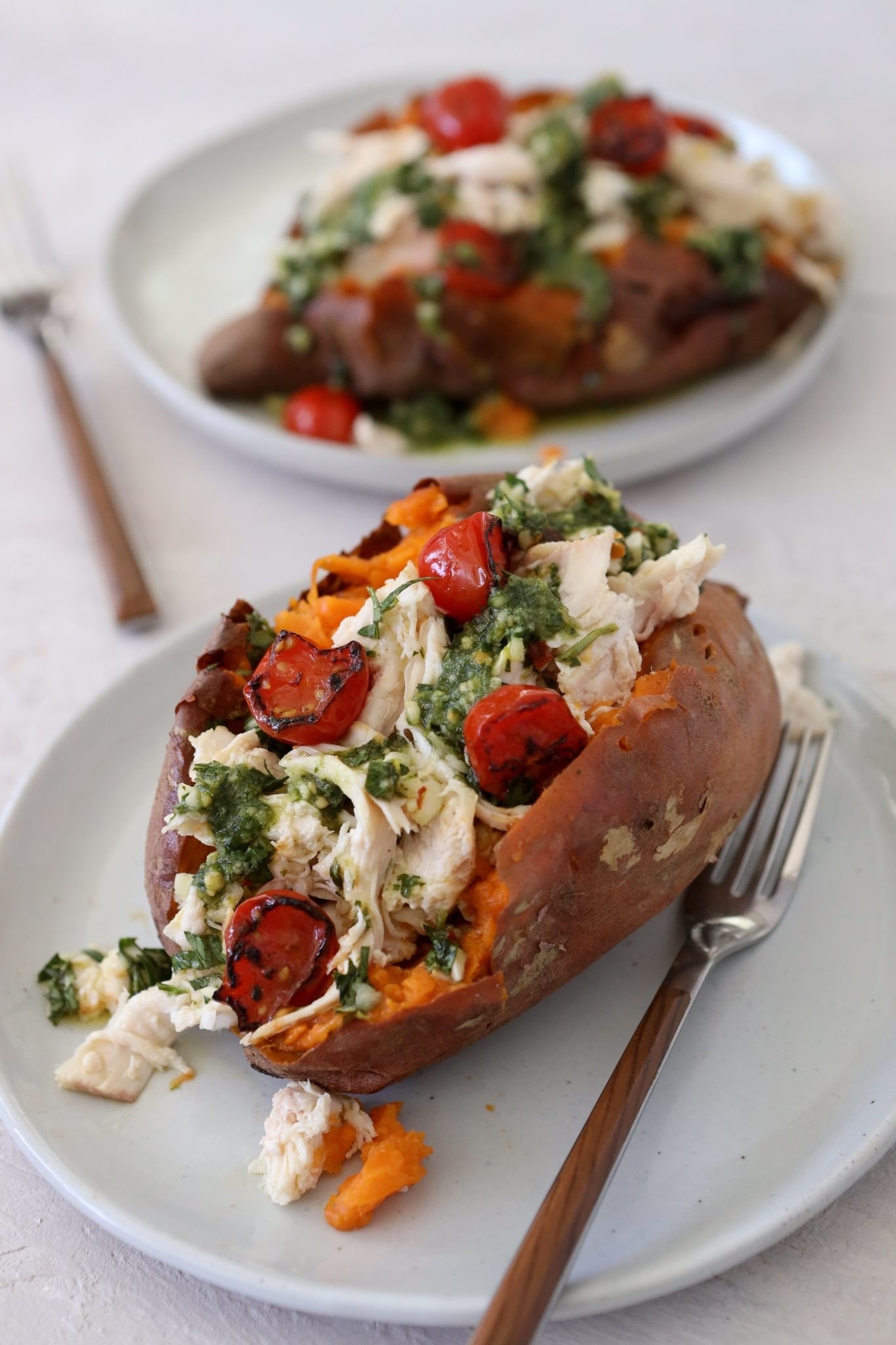A sweet potato stuffed with chicken, pesto, and tomatoes.