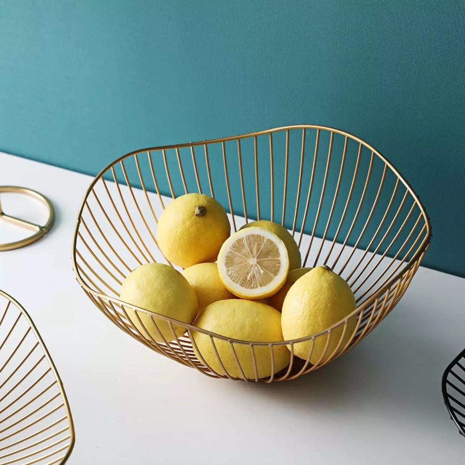 The gold wire fruit bowl with lemons inside