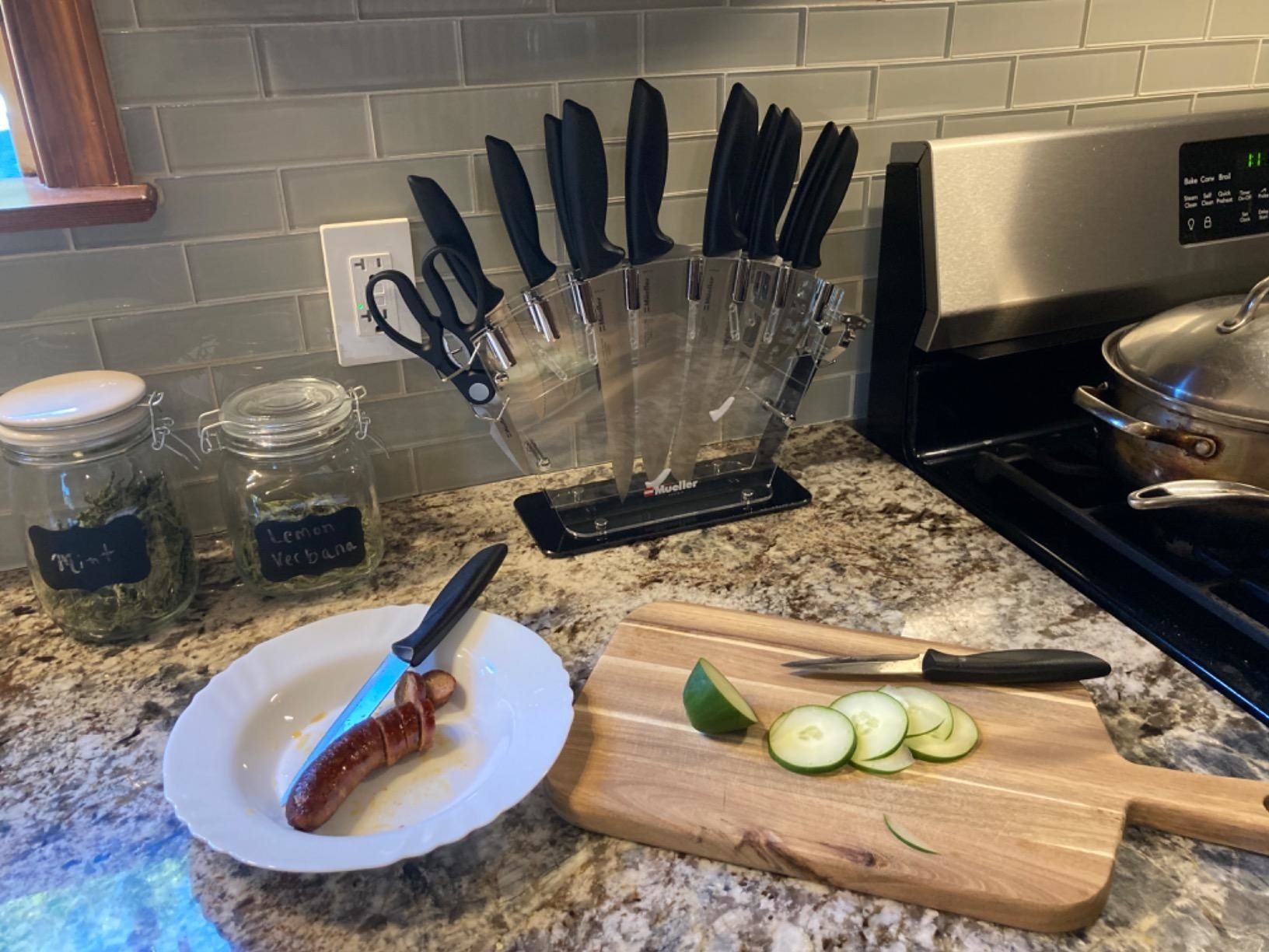 A clear acrylic base holding cooking knives