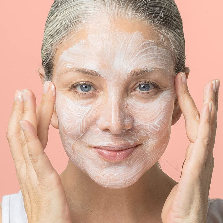 A model with the creamy white mask applied