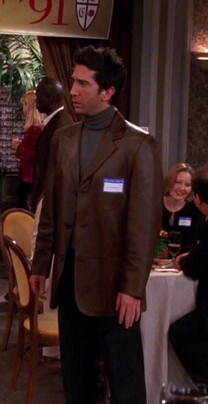 Ross wearing slacks, a turtleneck, and a big leather jacket