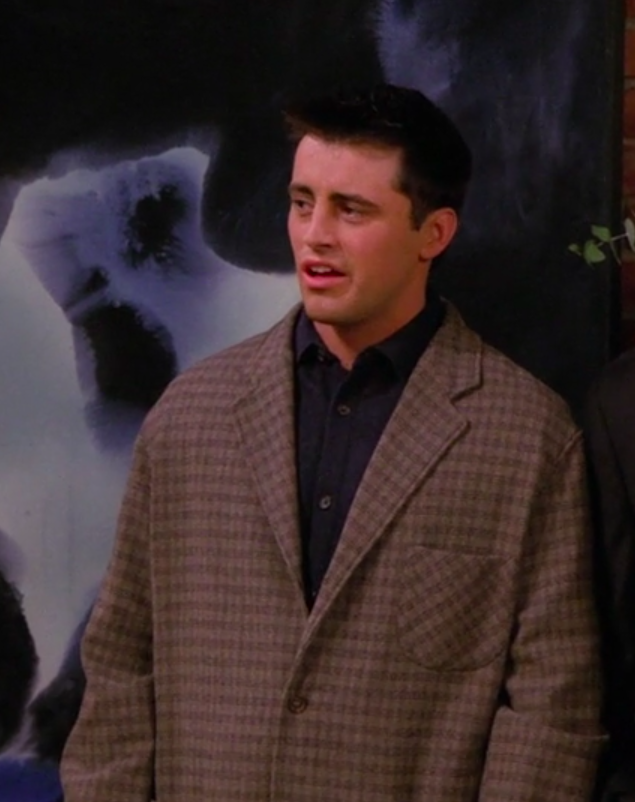 Joey wearing a big jacket and a long-sleeved button-up shirt