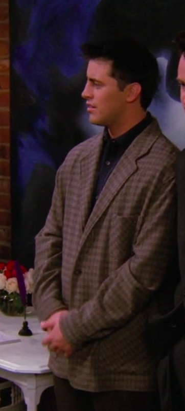 Joey wearing a big jacket and a long-sleeved button-up shirt