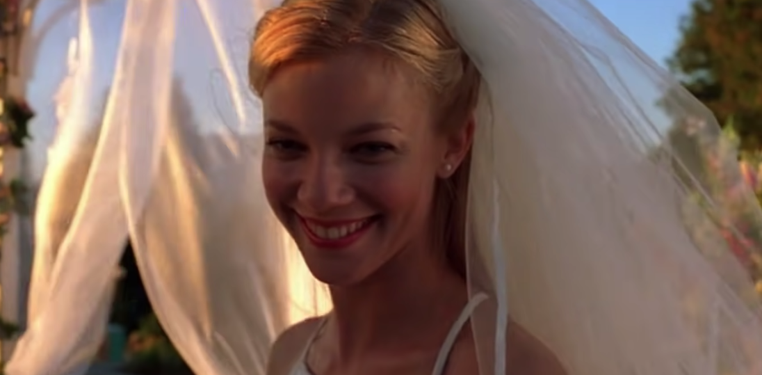 Kayleigh in a wedding dress smiling