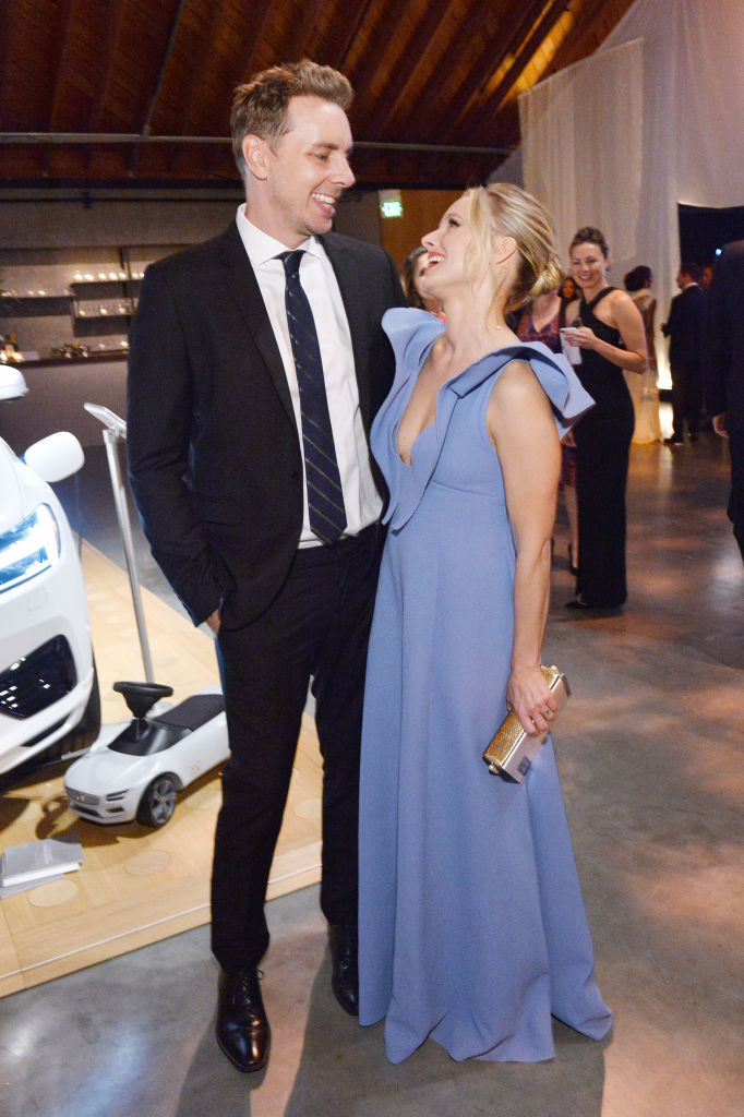 Dax Shepard (L) and Kristen Bell smile at each other as they attend an event