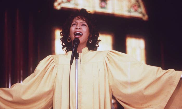 Whitney Houston wears a gold choir robe.