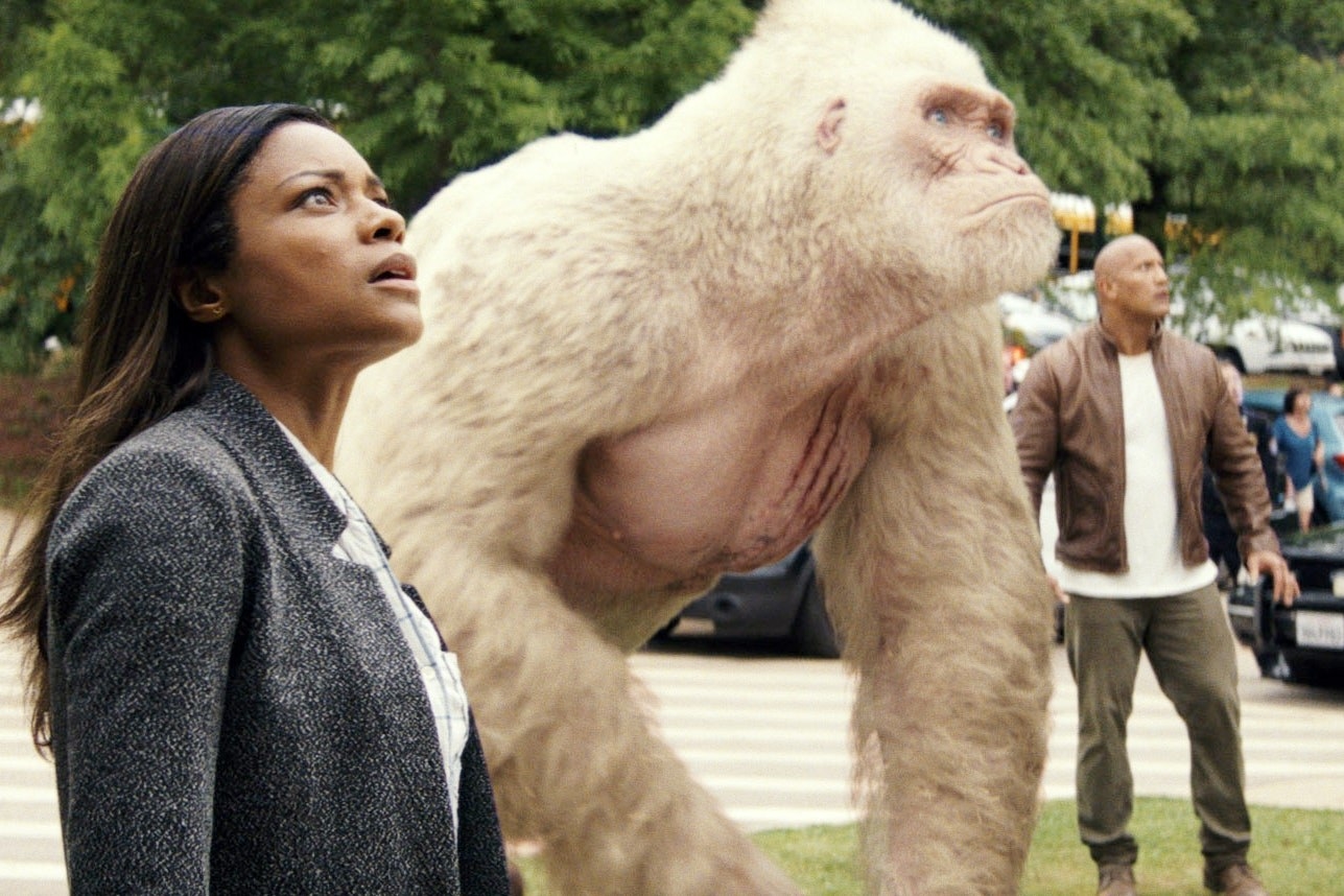 naomi harris as dr kate caldwell stands next to george the gorilla