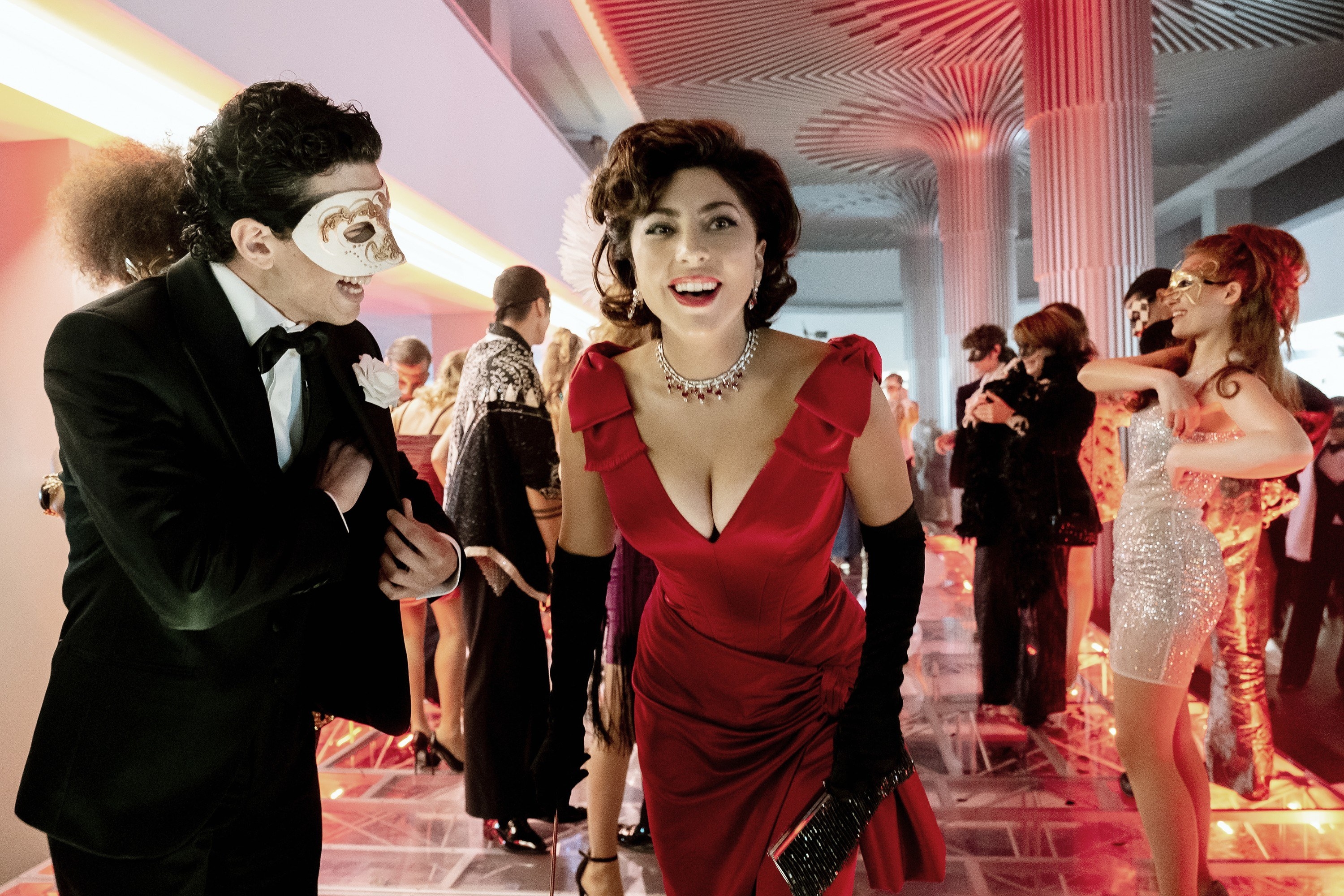 Gaga smiles while attending a masquerade ball in the movie