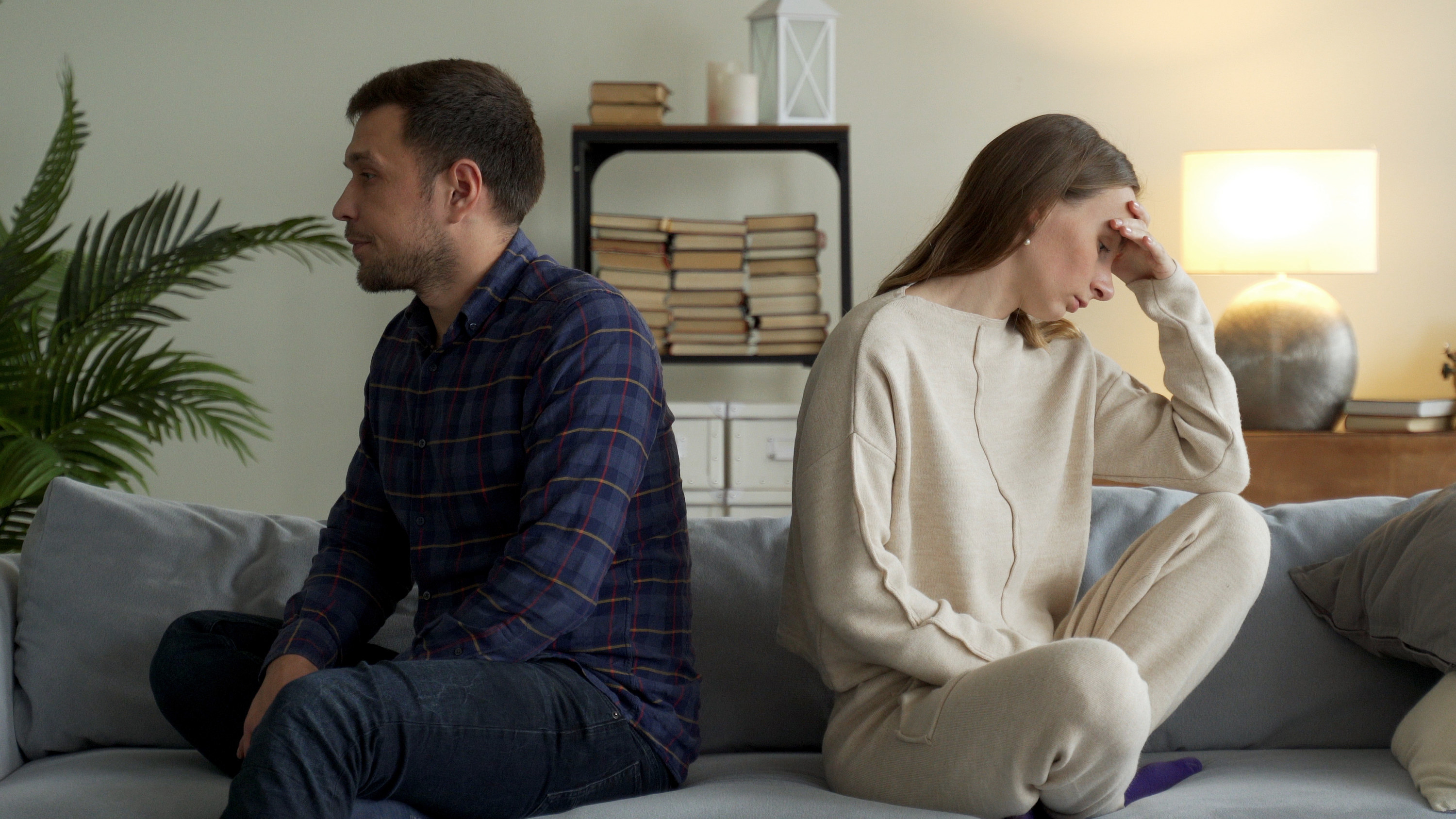 Couple sitting with their backs to each other during an argument