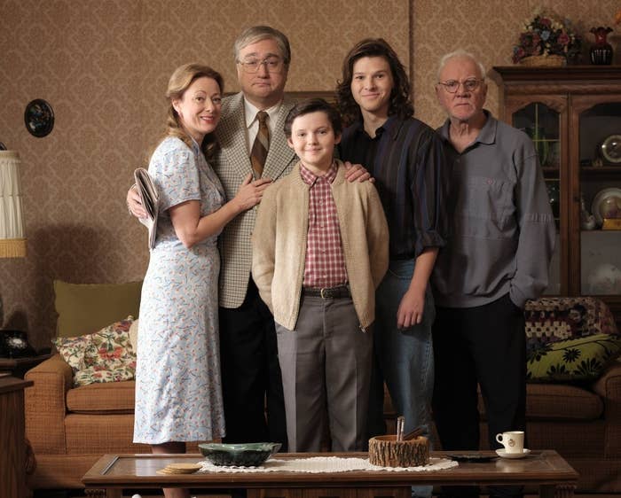 A photo of the family from the TV show in the &#x27;80s living room set wearing &#x27;80s clothing.