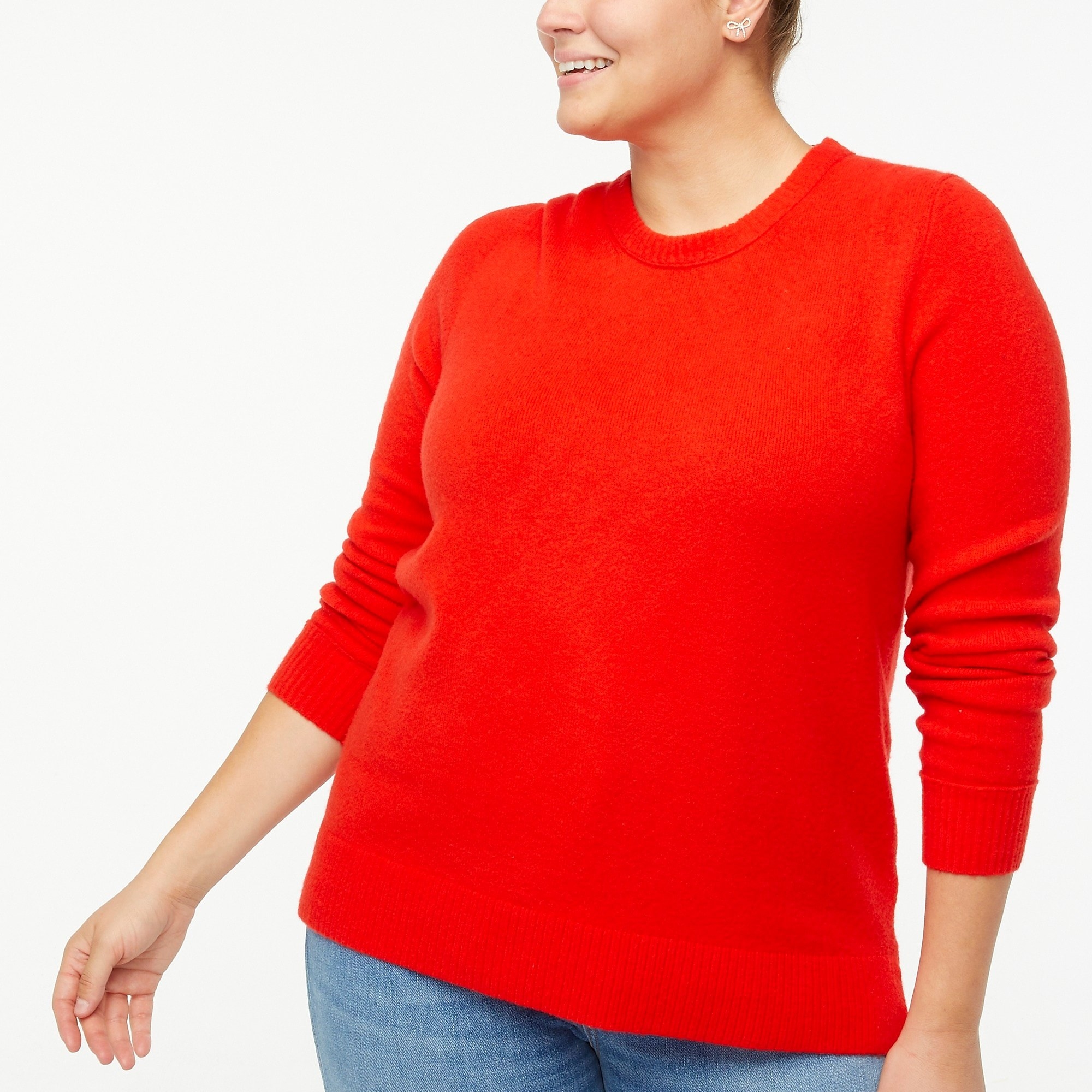 Model wearing red sweater with blue jeans