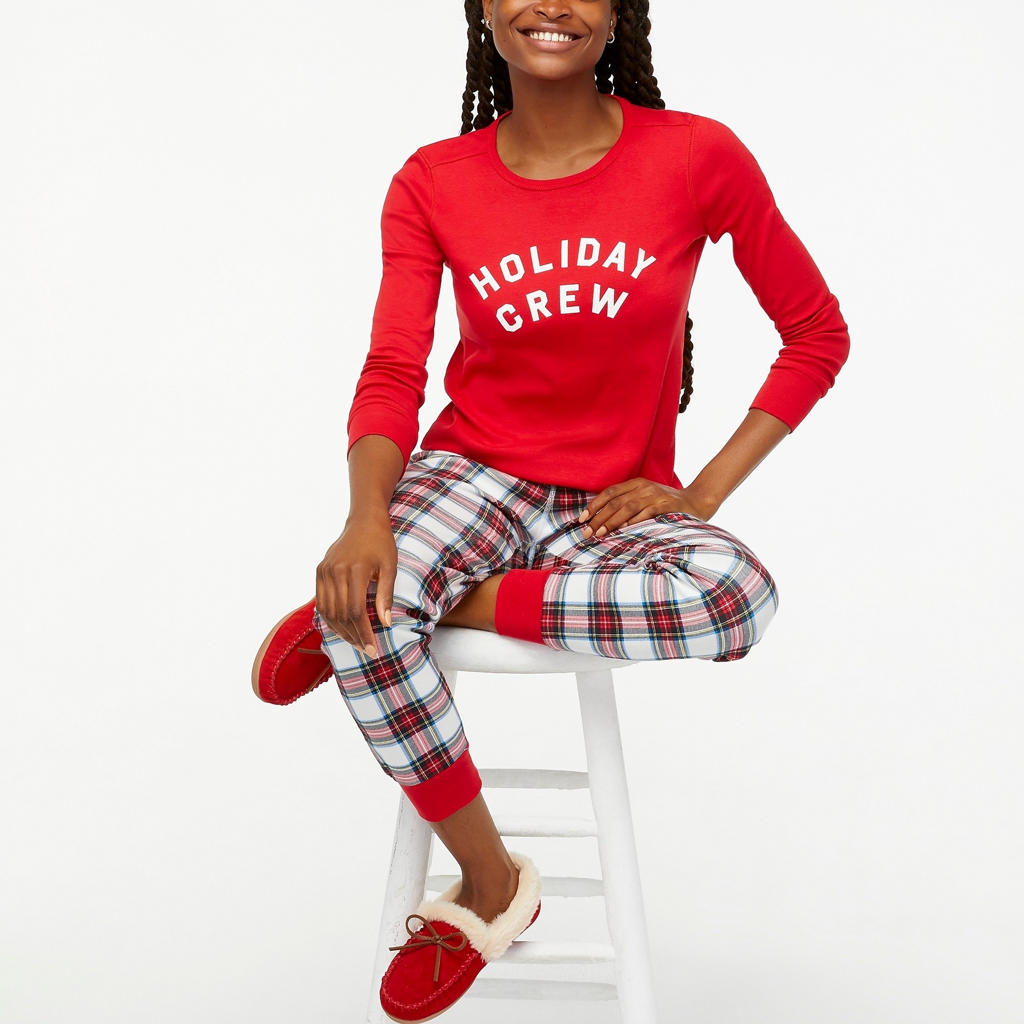Model wearing red top with red plaid pants and red shoes