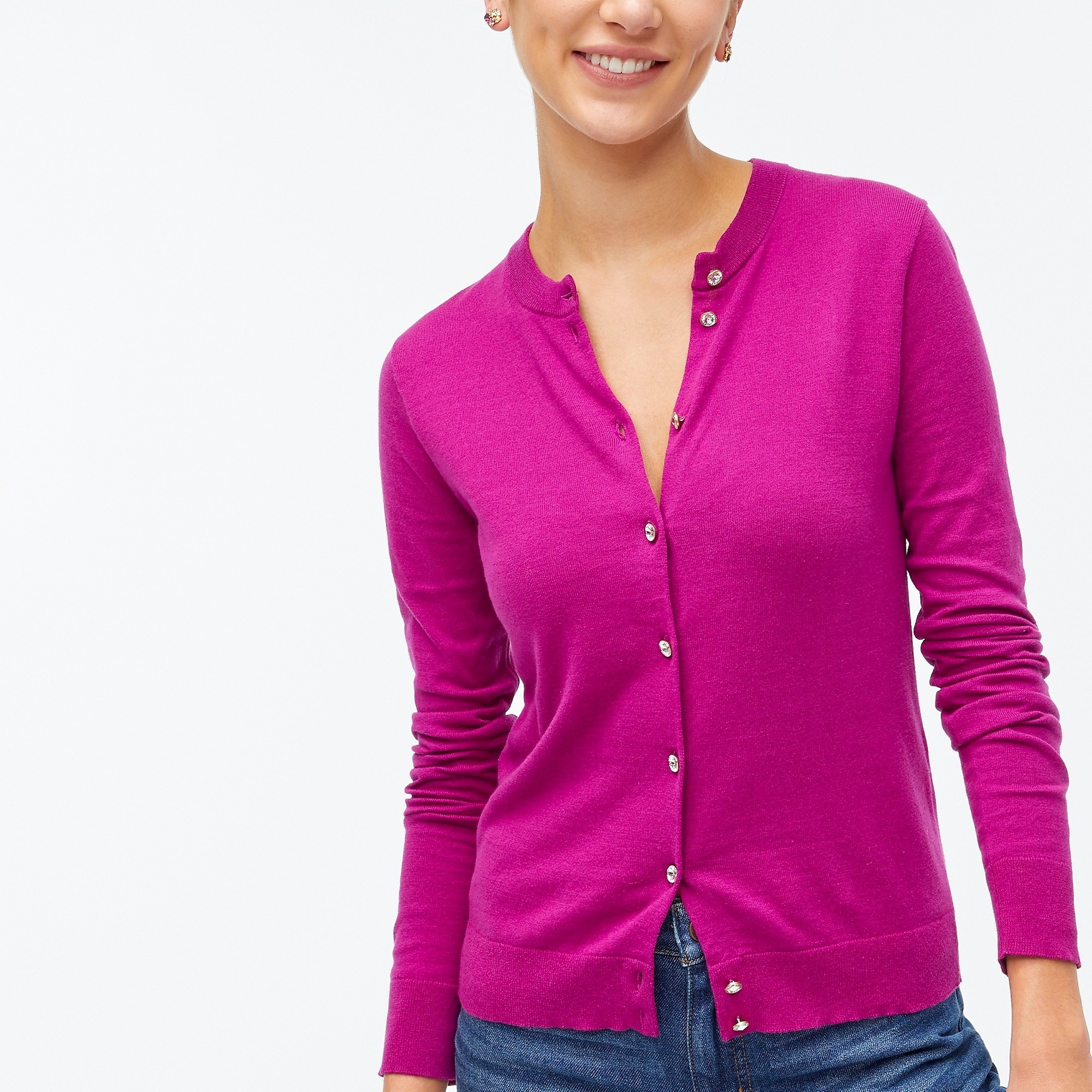 Model wearing a magenta cardigan with silver and diamond buttons