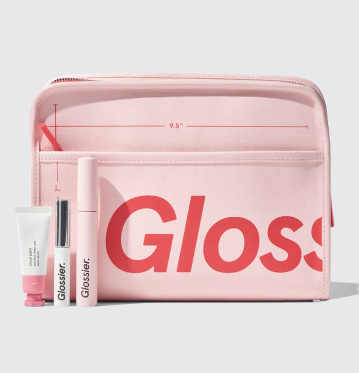pink Glossier makeup bag with Cloud Paint, Boy Brow, and Lash Slick