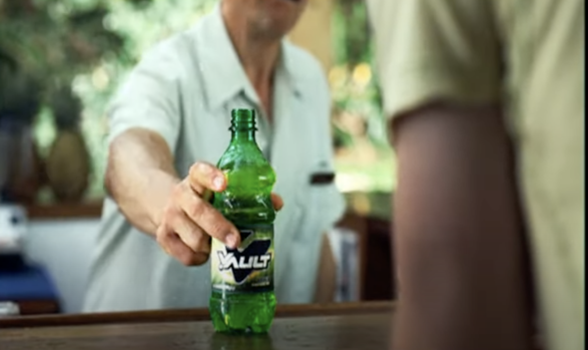Man placing Vault soda on a counter in Vault TV ad