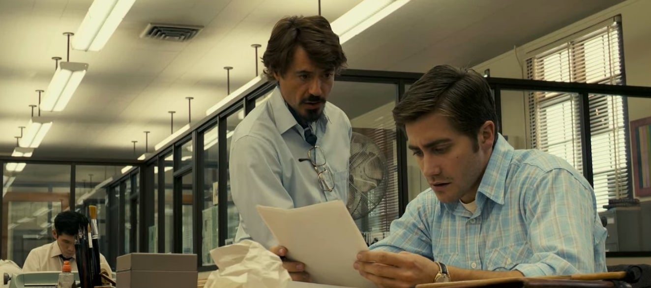 Robert and Paul looking at paper in &quot;Zodiac&quot;