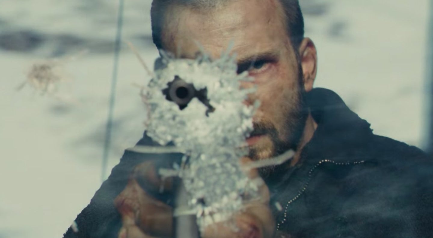 Curtis pointing a rifle out of a hole in a cracked window in &quot;Snowpiercer&quot;