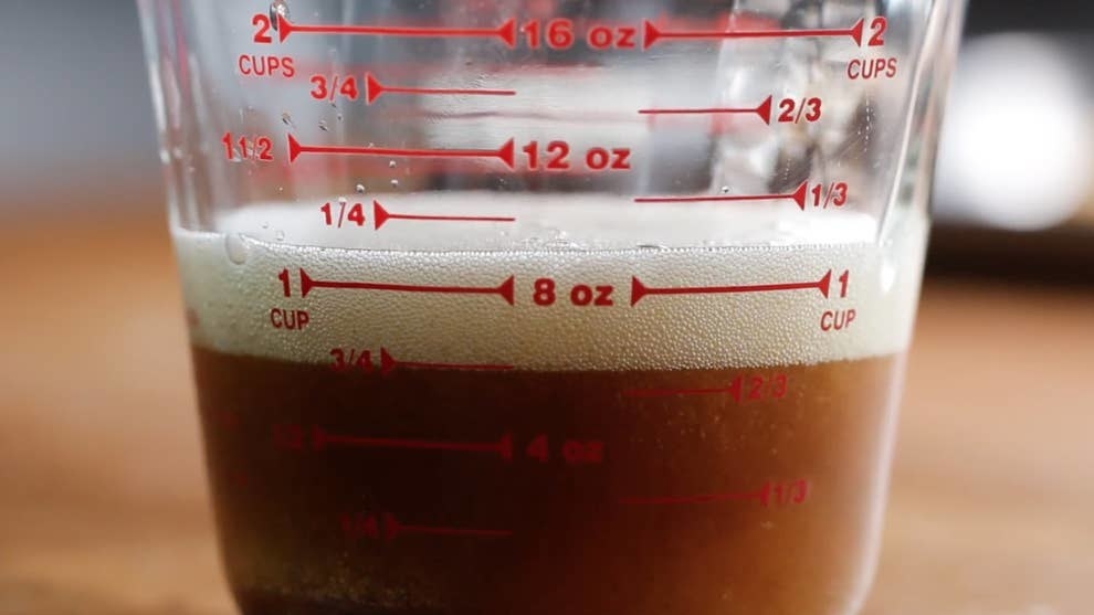 Brown butter in a measuring cup.