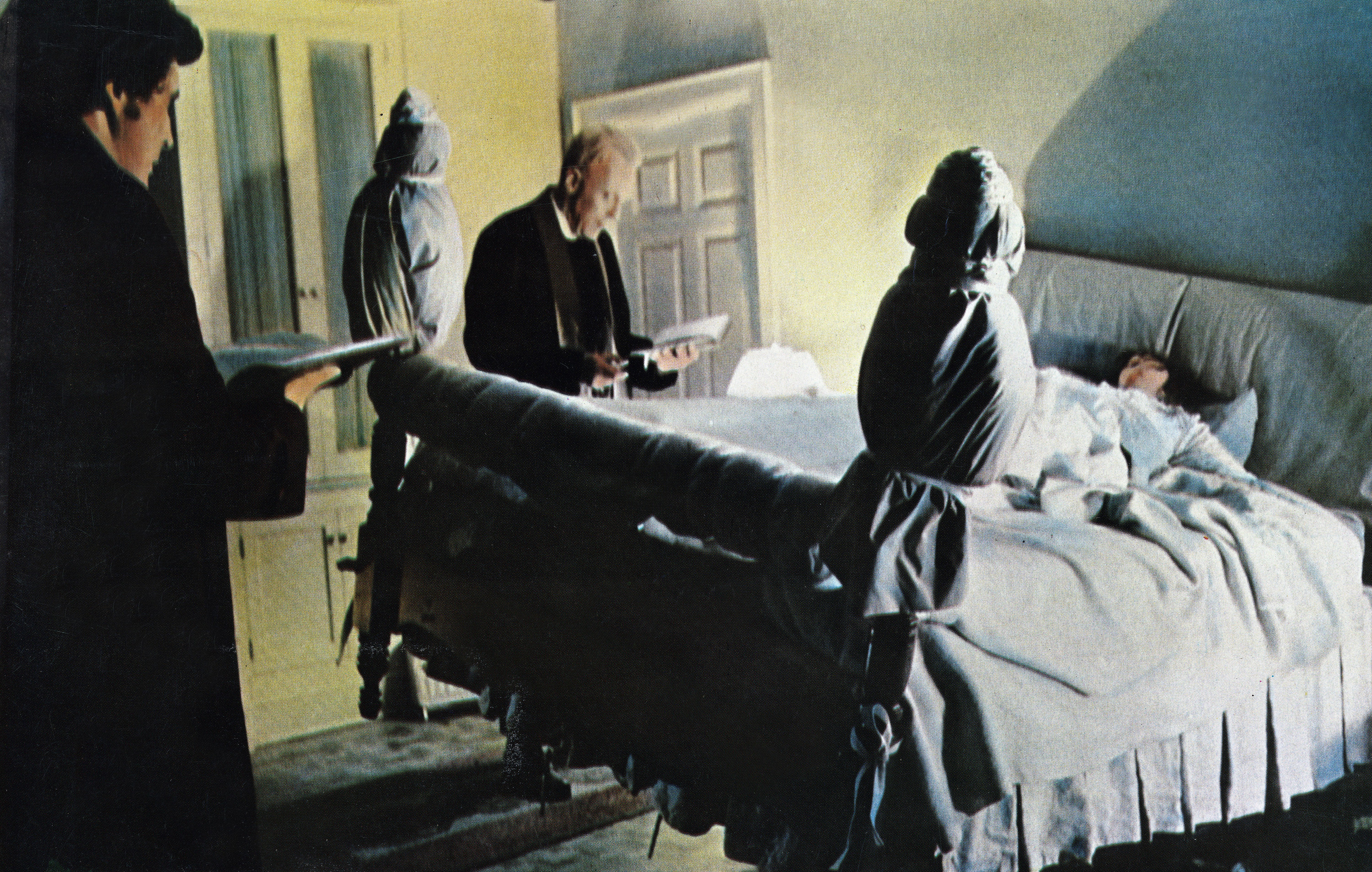 Fathers Karras and Merrin standing by Regan in her floating bed in &quot;The Exorcist&quot;