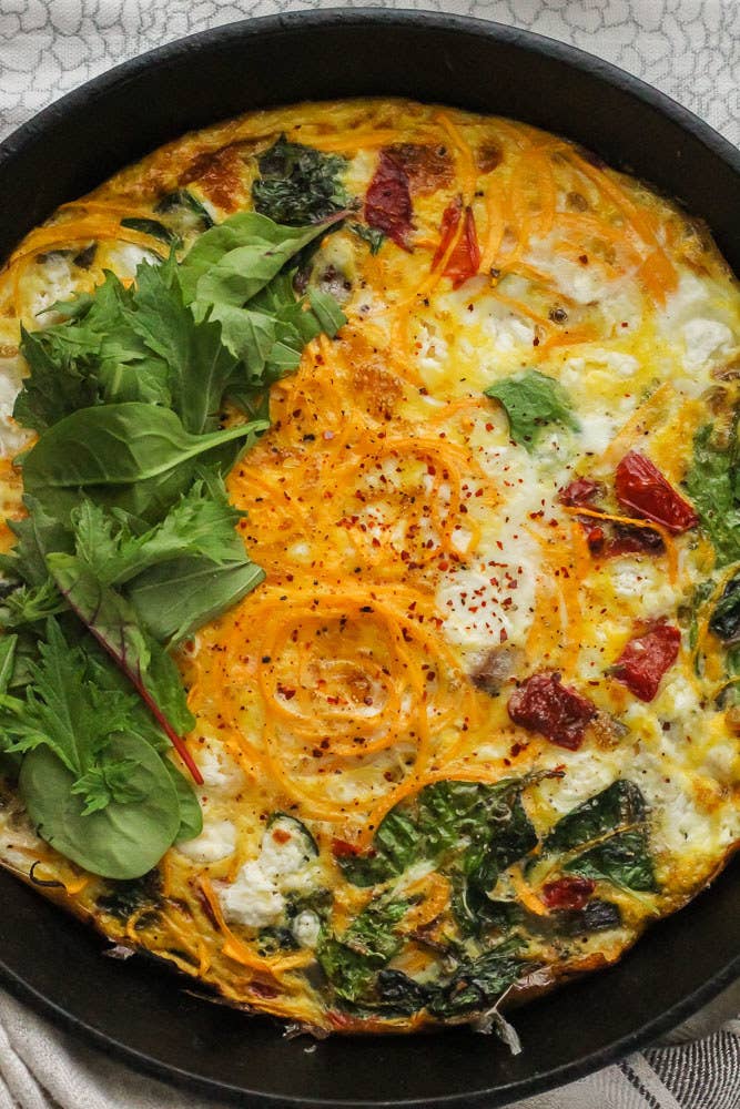 A frittata with butternut squash spirals and goat cheese.