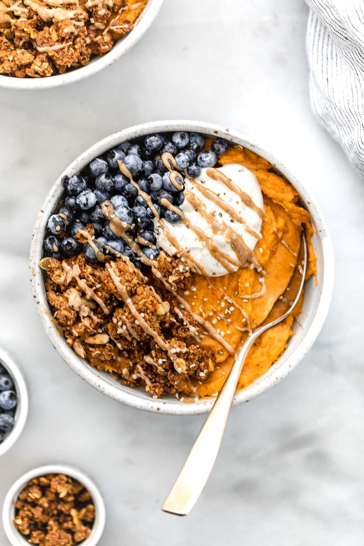 Sweet potato bowl with blueberries and granola clusters.