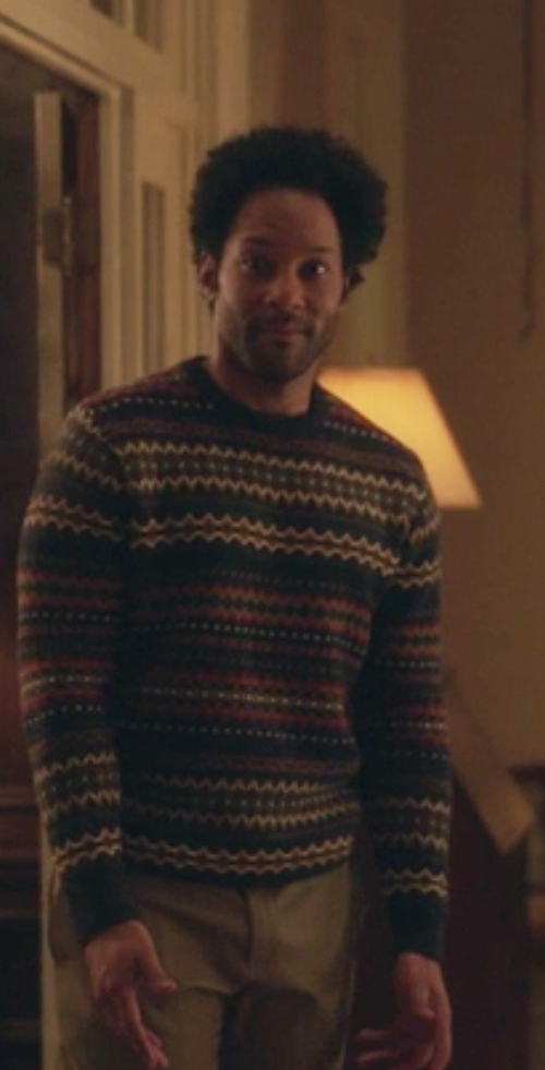 Nick Lott wears a patterned sweater and khakis