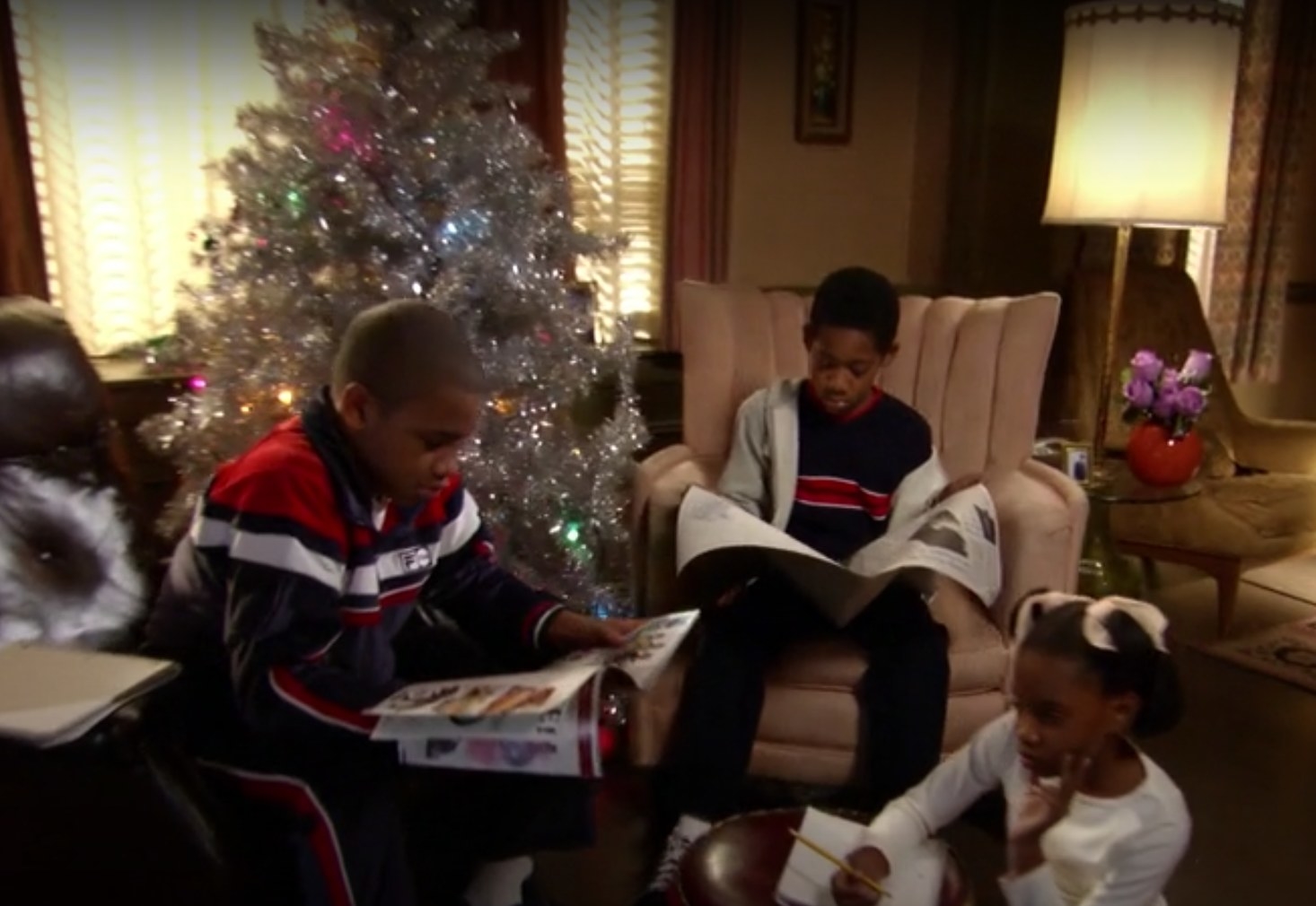 Characters Chris, Drew and Tonya gather by the Christmas tree in &quot;Everybody Hates Chris&quot;