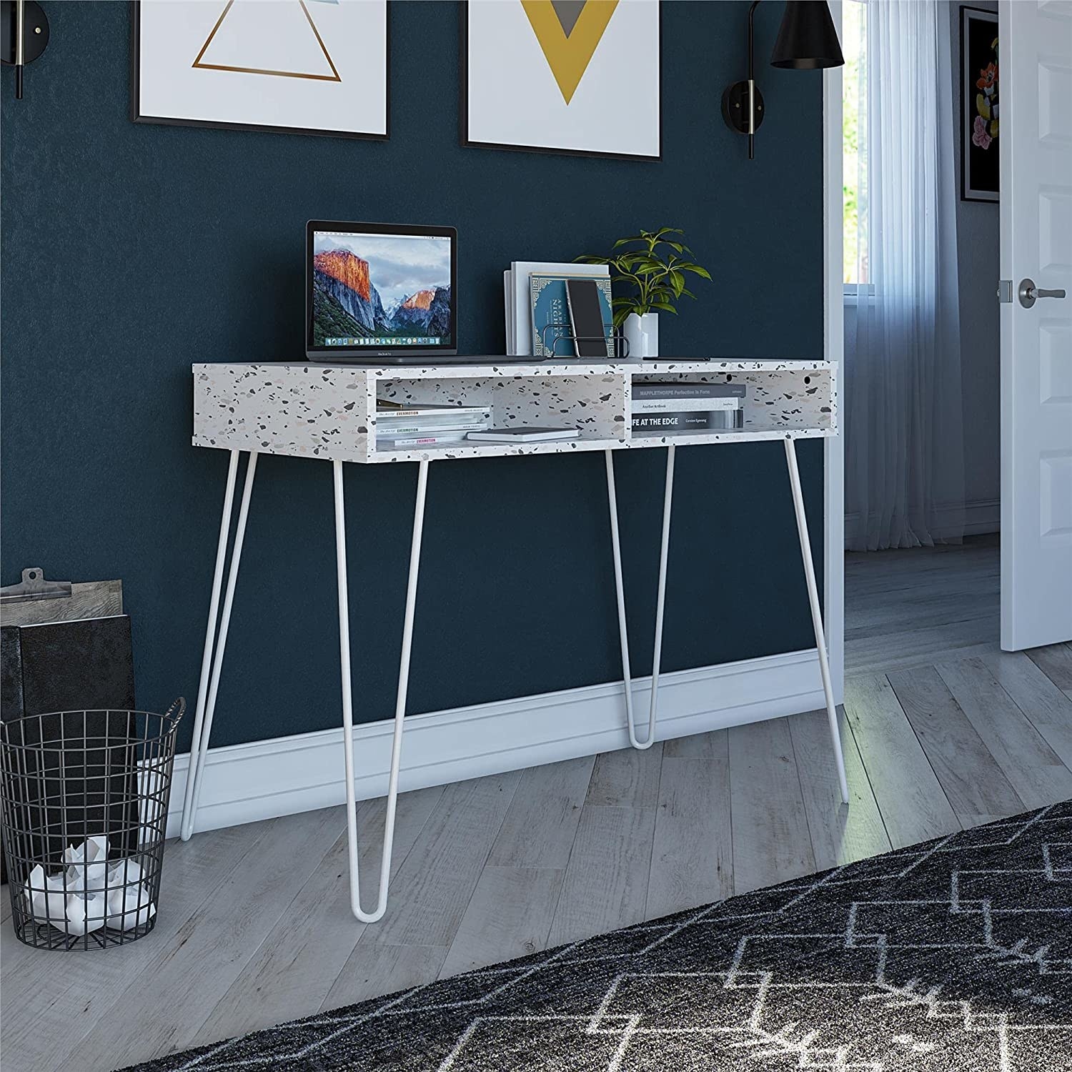 mid-century modern style terrazzo print desk with two open compartments with access in the front and white legs