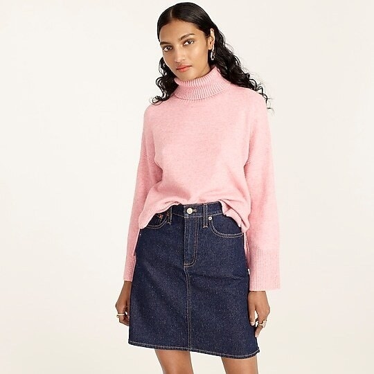 model wearing pink slouchy turtleneck with wide sleeves