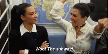 Kourtney sitting next to Kim on the train and saying &quot;Woo! The subway!&quot; as she waves her arms