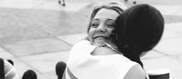 A close up of Blair Waldorf and Serena van der Woodsen as they hug each other tightly