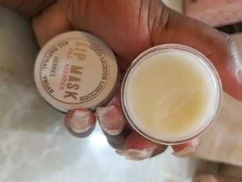 reviewer holding open jar of the overnight lip mask