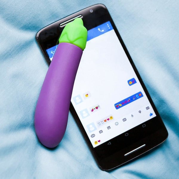 Purple eggplant vibrator next to cell phone