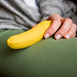 Model holding yellow banana vibrator