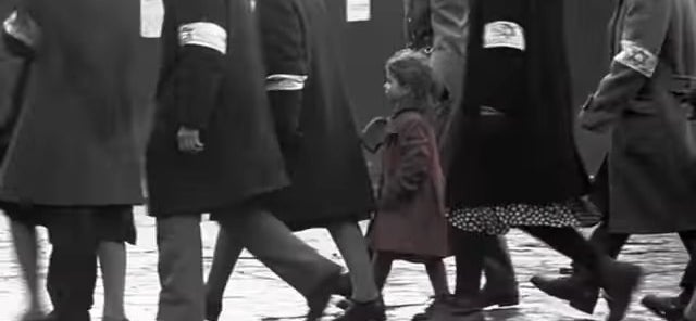 The girl in the red dress walking with other Jewish people in &quot;Schindler&#x27;s List&quot;