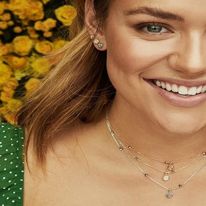 a model with a variety of the stud earrings in her ears