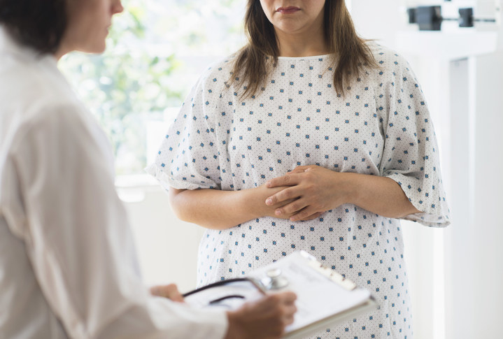 An overweight woman at the doctor receiving medical advice