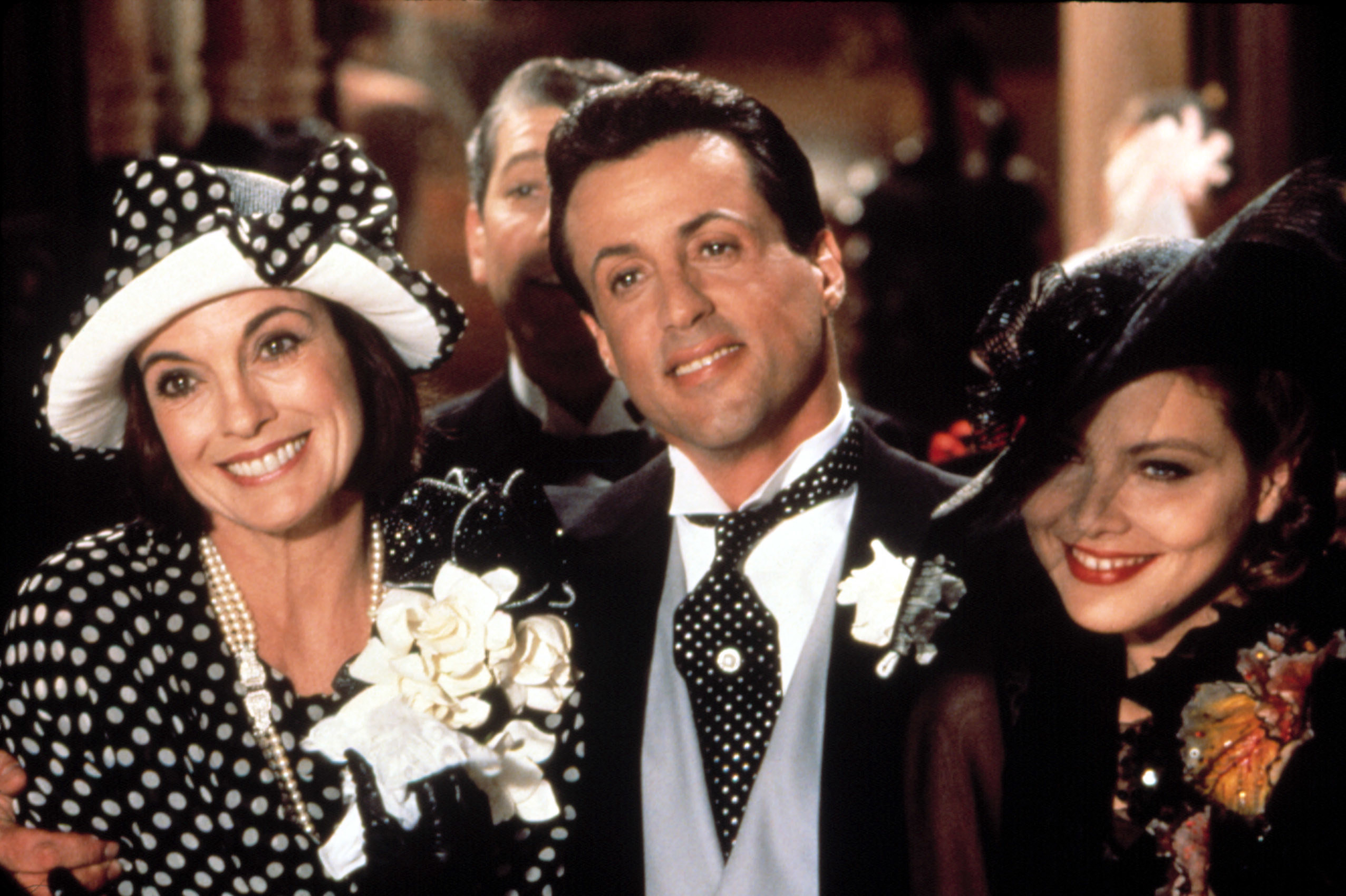 Linda Gray, Sylvester Stallone, Ornella Muti dressed in fancy clothes for a party, smiling