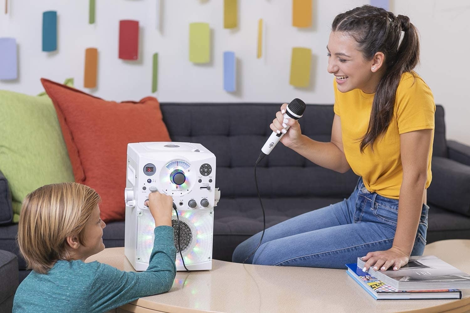kids play with white karaoke machine that comes with microphone and LED disco lights