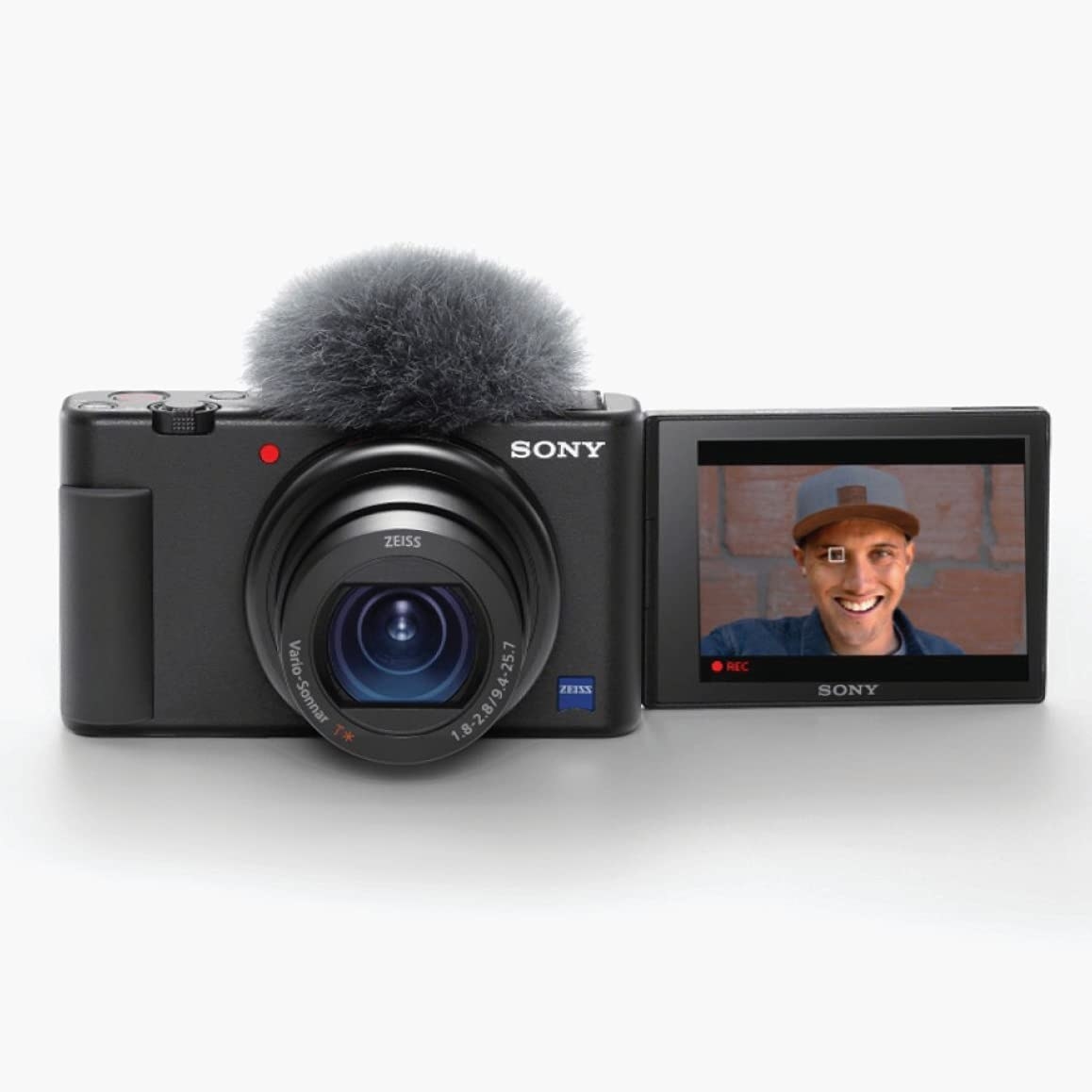 Black compact camera with screen flipped around for selfies or recording vlogs