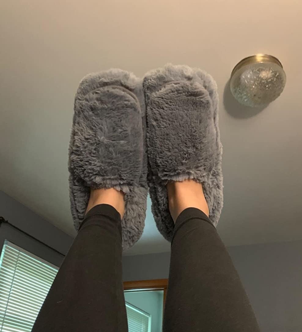 a reviewer wears the gray slippers