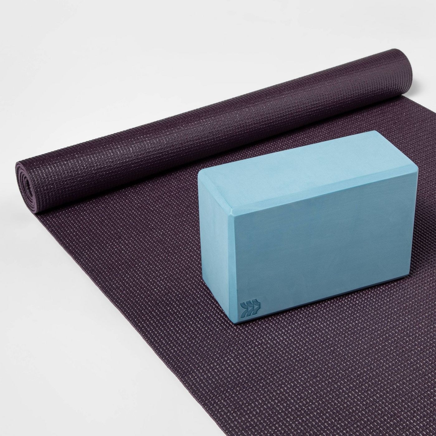 A blue block on a yoga mat