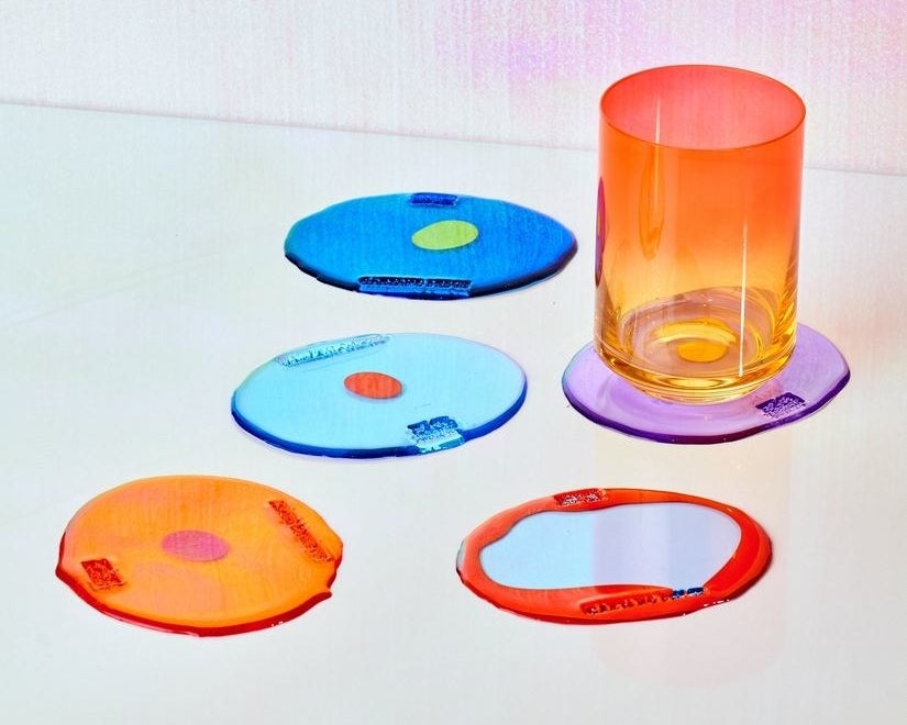 colorful orange, blue, and violet resin coasters on table