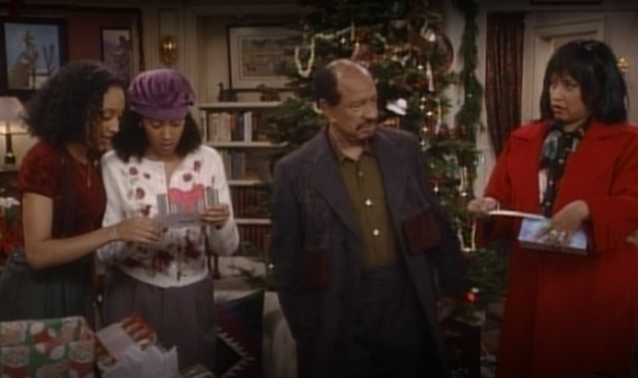 Characters Tamera Campbell, Tia Landry, Grandpa Campbell, and Lisa Landry gather by the Christmas tree in &quot;Sister, Sister&quot;